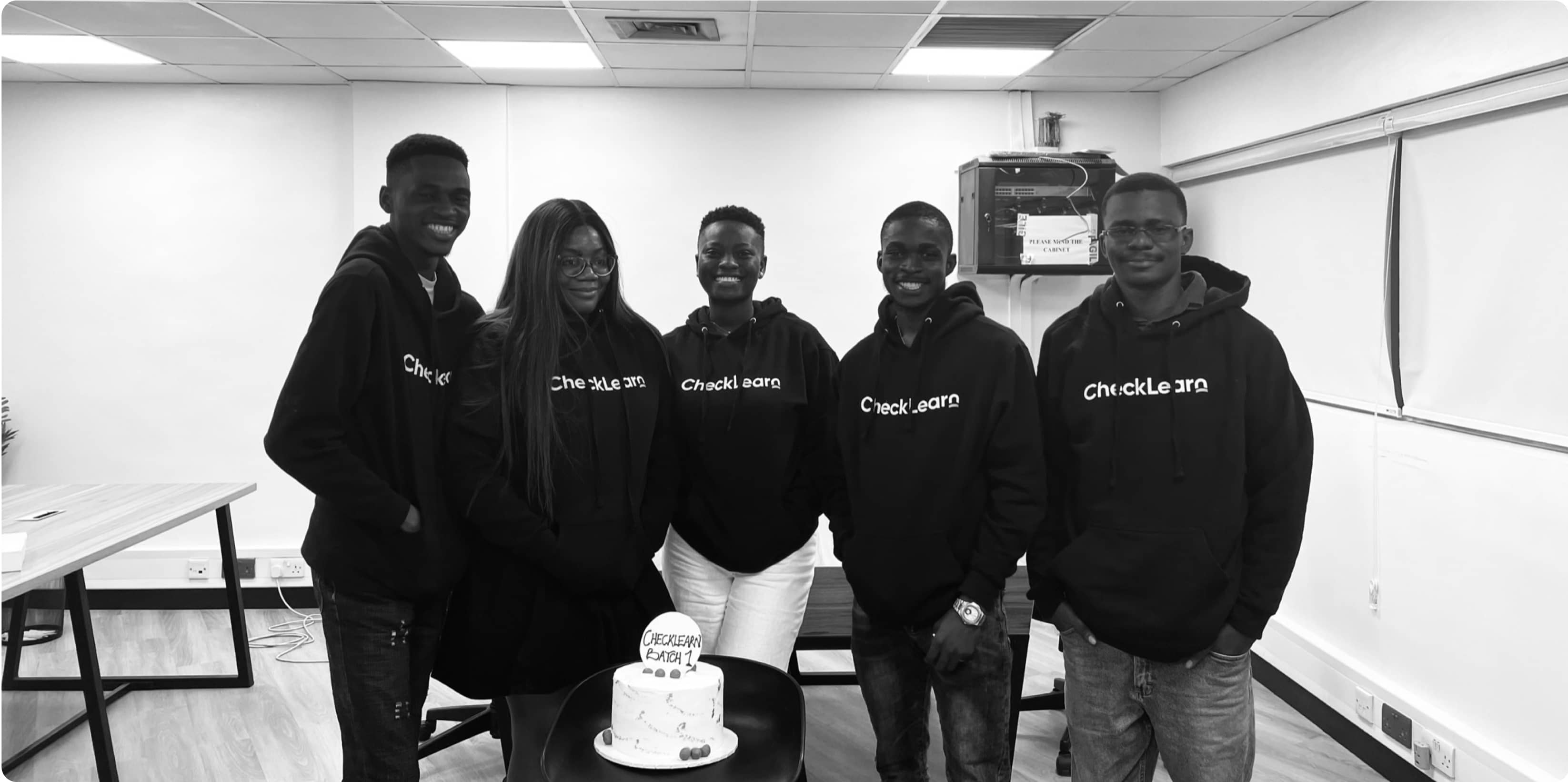 checklearn-students-in-front-of-a-cake